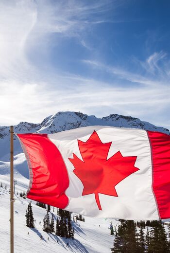 Canadian flag flying at the top of the Rendezvous on top of Whistler Mountain.