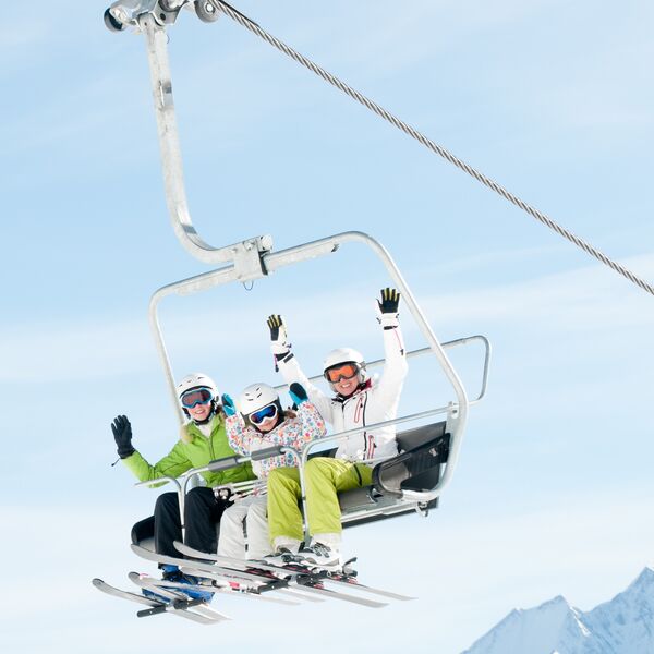 Winter - ski vacation - family on ski lift 