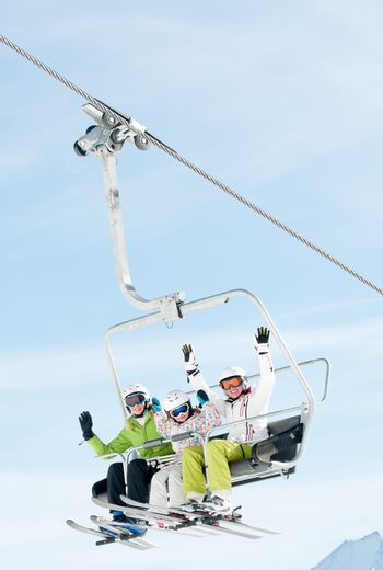 Winter - ski vacation - family on ski lift