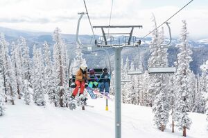  Mother and two young daughters snowboard in Keystone, CO.