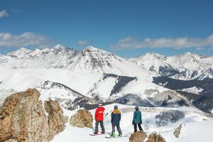 Ski & Ride School group of snowboarders looking out at Teocalli Mountain 