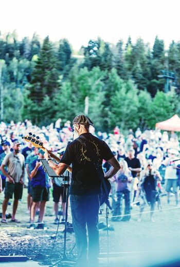 Group of people watch performs at a summer concert