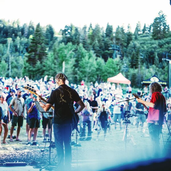 Group of people watch performs at a summer concert